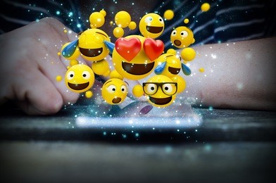 woman hand touch smartphone screen with  emoticons