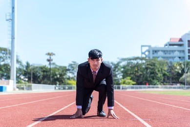 business start competition on track. kneeling on the start. motivation and success business concept.