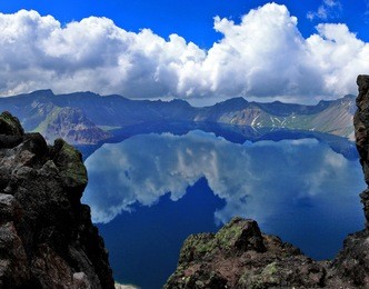 reflection of sky at heaven lake on top of changbai mountain or baekdu mountain overlooking north korea from jilin province, china.