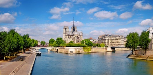 paris, river seine with notre-dame cathedral from the back on a bright day in spring, panoramic image