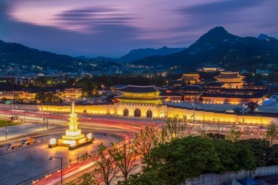 gyeongbokgung palace at night in south korea, with the name of the palace 'gyeongbokgung' on a sign