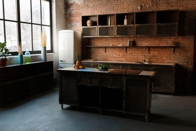 modern kitchen interior with red brick wall, big window and wooden table