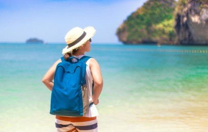 traveler asian woman  with backpack on the beach krabi,thailand