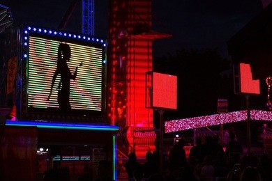 neon signs showing a dancing lady - night life in paris, france.