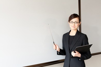 a young asian teacher teaching in the classroom
