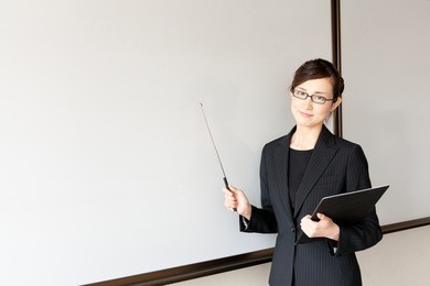 a young asian teacher teaching in the classroom