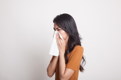 young asian woman got sick and flu on white background