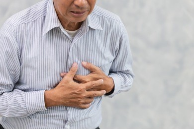 asian elder suffer from chest pain from heart attack or stroke.