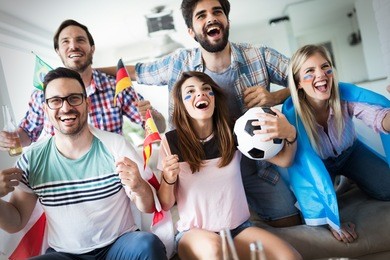 group of multi-ethnic people celebrating football game