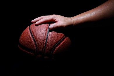 hands holding  basketball balls on gray studio background. concept of confrontation.