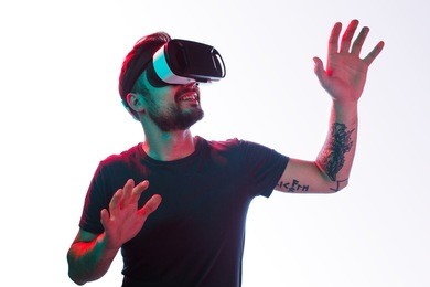 casual bearded man with tattoo trying vr headset and exploring another world isolated on white. 