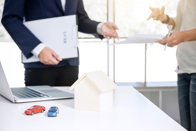 car and home for rent concept, broker agent presenting and consult to customer to decision making sign form agreement, home and car model.