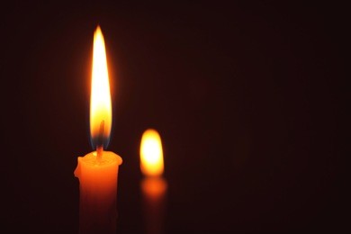 lighting of candles for background, lighting candles, two candles in night time 