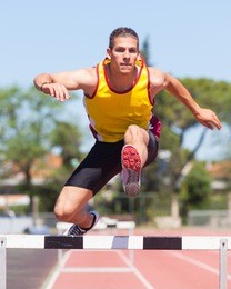 male track and field athlete during obstacle race