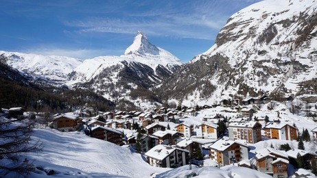zermatt city view with matterhorn background in a sunny day of winter season at zermatt, switzerland. zermatt village with snow on the roof. cityscape view from gornergrat bahn