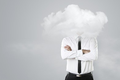 young businessman with head in the clouds