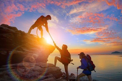 climbing team are on the climb to the cliff,hiking and team work concept.  
              