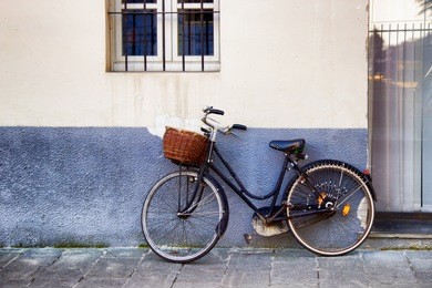 old black retro bicycle with basket on the street 