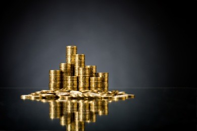 still life of very many rouleau gold  monetary or change coin, on dark blue background