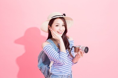 beauty woman take camera and smile happily on the pink background