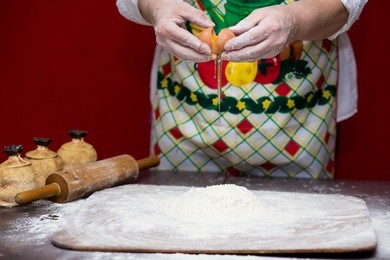 female hands making dough for pizza. making bread. cooking process concept