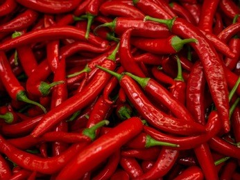 red hot chilli peppers pattern texture background. close up. landscape. a backdrop ofred hot chilli peppers. street vegetable market. group of red hot chilli peppers