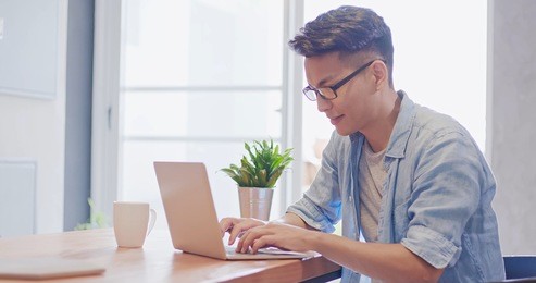 man sit and use notebook work in the morning