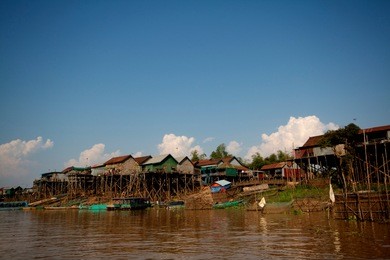 tonle sap floating village is an amazing water world on the banks of a river feeding into the tonle sap lake. houses are built on stilts or float to cope with the huge change in water levels.
