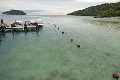 wooden dock with floating guide line near the beach at manukan island, sabah, malaysia