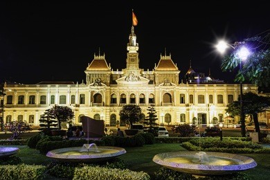 ho chi minh city hall in ho chi minh city, vietnam at night. it is known as ho chi minh city people's committee head office and was built in 1902-1908.