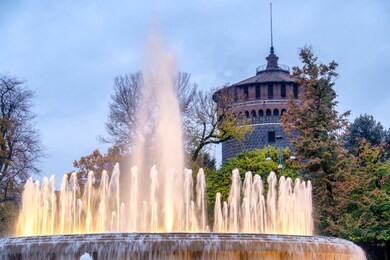 milan, lombardy, italy: the castle known as castello sforzesco and the fountain at evening