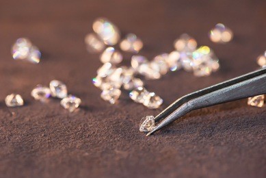 diamond with tweezers and magnifier.gemstone beauty