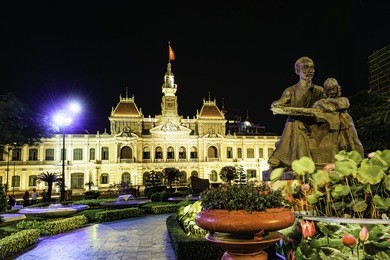 ho chi minh city hall in ho chi minh city, vietnam at night. it is known as ho chi minh city people's committee head office and was built in 1902-1908.