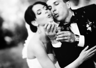 beautiful wedding couple blowing bubbles