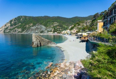 beautiful scenery sea view at monterosso al mare, cinque terre, italian riviera. empty beach with crystal blue water and hills at the background. vacation mediterranean concept, holiday postcard. 