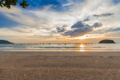 sailboats resting after regatta at kata beach phuket island thailand in sunset lights