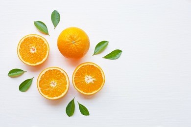 fresh orange citrus fruit with leaves isolated on white background.  top view