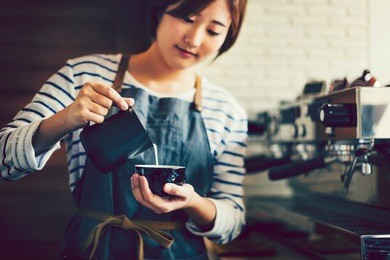 asian barista creating latte art