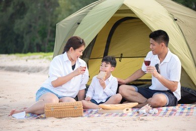 summer vacation. family camping on beach with tent.