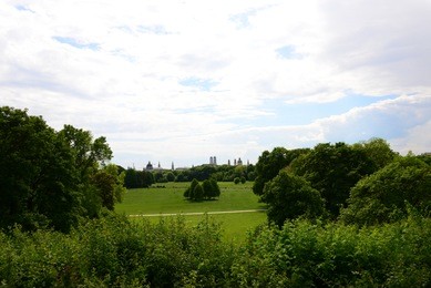 in the english garden in munich - view of the city of munich, frauenkirche, bavaria, germany, may 20, 2014