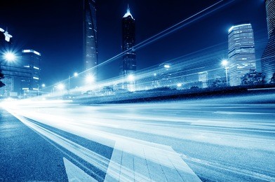 moving car with blur light through city at night