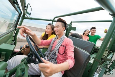 group of young people traveling by car