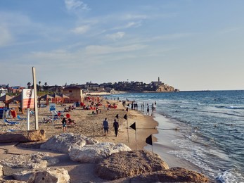the beach in tel aviv, next to the old jaffa at sunset.   
