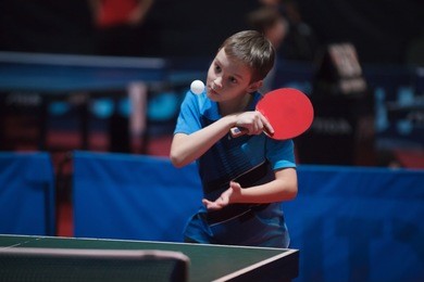 photo of professional table tennis player young boy. junior. championship tournament.