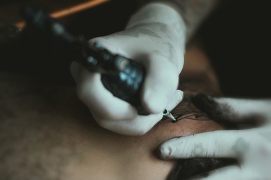 tattoo artist tattooing client