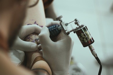 tattoo artist tattooing client