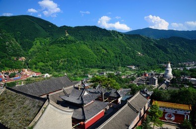view from the pusading temple across the historic village of wutaishan with its characteristic white pagoda (baita), in shanxi, china