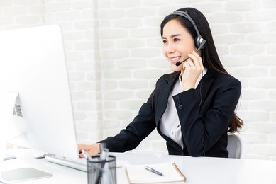 young beautiful asian businesswoman wearing headphone working in call center office as a customer service operator