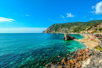 the sandy beach at the italian village of monterosso al mare on the ligurian coast, part of the cinque terre, an unesco world heritage site.