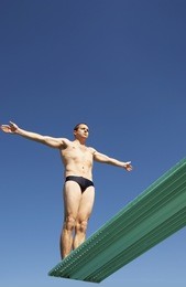 low angle view of a diver ready to dive of the springboard